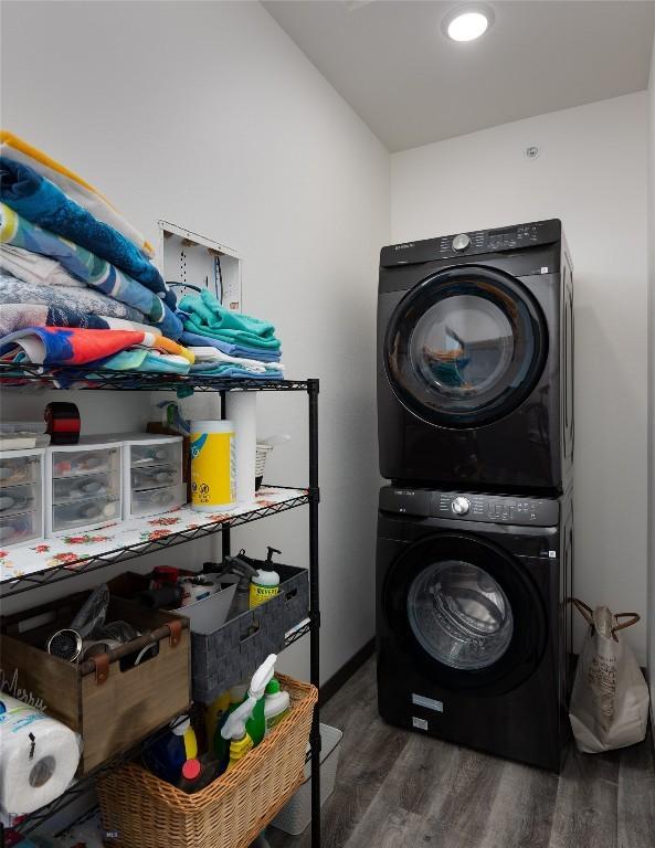 223 New Ventures Dr, Bozeman, MT 59718 - laundry room featuring stacked washer and clothes dryer and wood finished floors