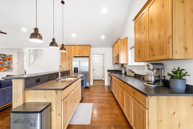 38 Red Rock, Bozeman, MT 59718 - kitchen featuring appliances with stainless steel finishes, dark countertops, light brown cabinets, wood finished floors, and recessed lighting