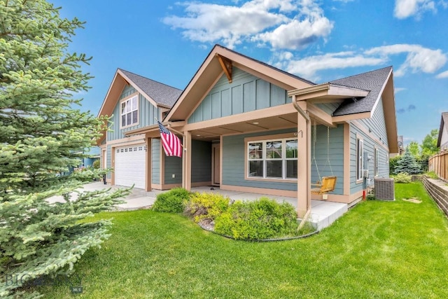 38 Red Rock, Bozeman, MT 59718 - view of front of house with board and batten siding, an attached garage, a front lawn, and roof with shingles