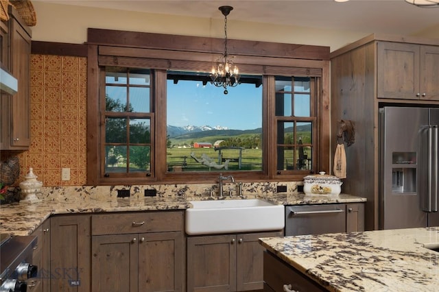 1400 Cottontail Rd, Gallatin Gateway, MT 59730 - kitchen with stainless steel fridge with ice dispenser, tasteful backsplash, a chandelier, pendant lighting, and light stone counters