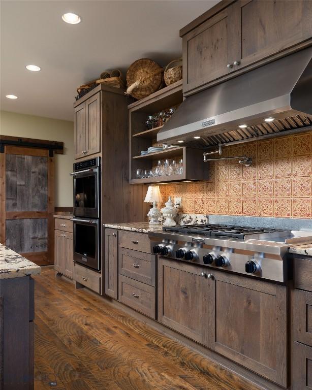 1400 Cottontail Rd, Gallatin Gateway, MT 59730 - kitchen with appliances with stainless steel finishes, under cabinet range hood, recessed lighting, backsplash, and dark wood-style flooring