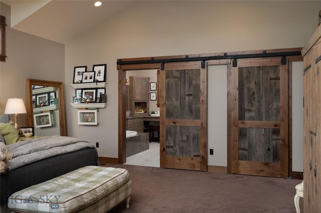 1400 Cottontail Rd, Gallatin Gateway, MT 59730 - bedroom with a barn door, carpet floors, recessed lighting, and high vaulted ceiling