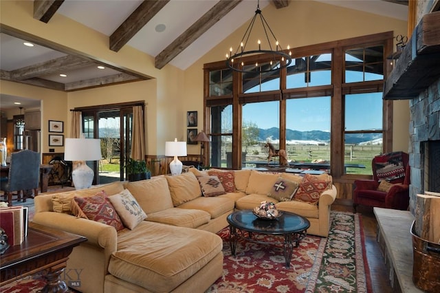 1400 Cottontail Rd, Gallatin Gateway, MT 59730 - living area with a mountain view, a chandelier, wood finished floors, and a stone fireplace