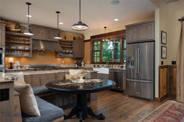 1400 Cottontail Rd, Gallatin Gateway, MT 59730 - kitchen featuring appliances with stainless steel finishes, open shelves, under cabinet range hood, dark wood finished floors, and backsplash