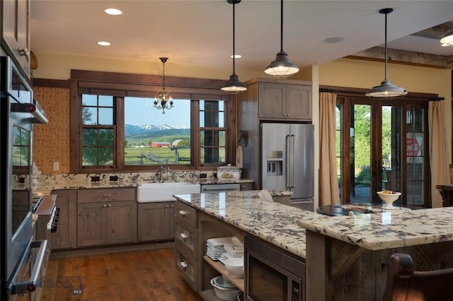 1400 Cottontail Rd, Gallatin Gateway, MT 59730 - kitchen with stainless steel appliances, light stone countertops, dark wood-style flooring, healthy amount of natural light, and recessed lighting