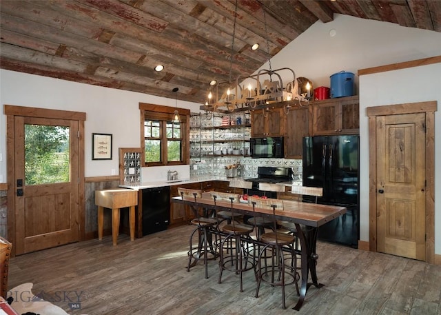 1400 Cottontail Rd, Gallatin Gateway, MT 59730 - kitchen featuring black appliances, a wood ceiling with exposed beams, wood finished floors, a wainscoted wall, and plenty of natural light