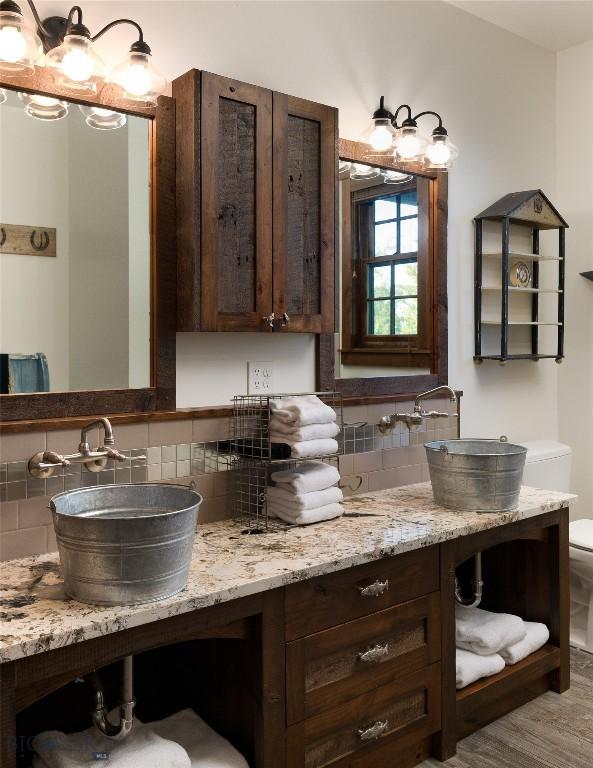1400 Cottontail Rd, Gallatin Gateway, MT 59730 - bathroom featuring tasteful backsplash and vanity