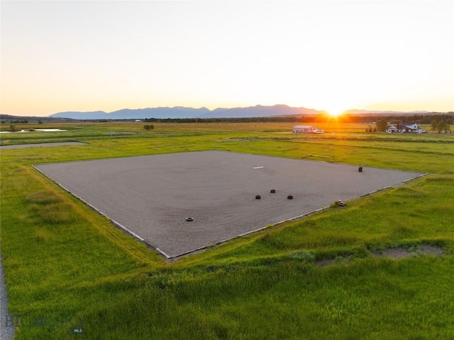 1400 Cottontail Rd, Gallatin Gateway, MT 59730 - patio terrace at dusk featuring a mountain view and a lawn