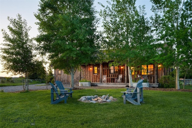 1400 Cottontail Rd, Gallatin Gateway, MT 59730 - rear view of property featuring a lawn and a fire pit