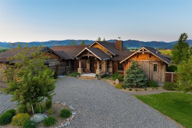 1400 Cottontail Rd, Gallatin Gateway, MT 59730 - craftsman house featuring a chimney, a mountain view, stone siding, driveway, and a porch