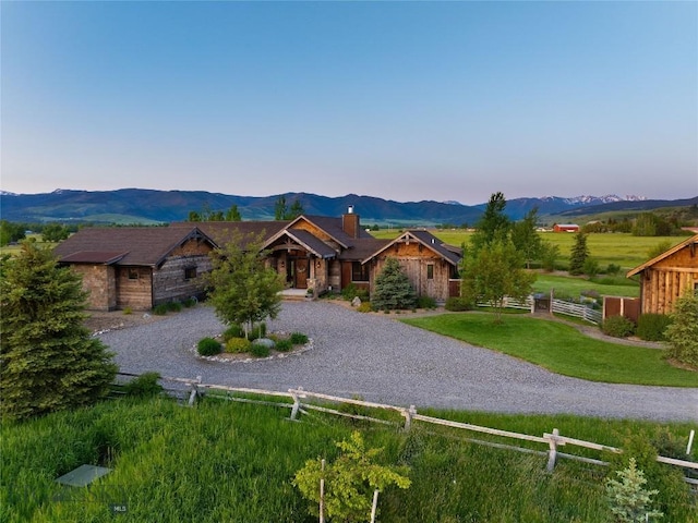 1400 Cottontail Rd, Gallatin Gateway, MT 59730 - view of front facade featuring a chimney, a mountain view, and curved driveway