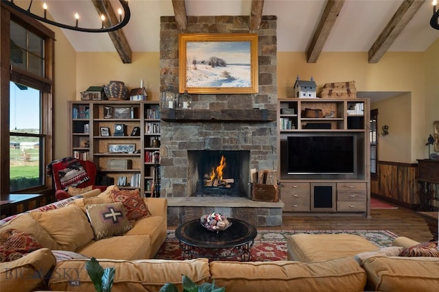 1400 Cottontail Rd, Gallatin Gateway, MT 59730 - living room with a chandelier, wood finished floors, a fireplace, and a wainscoted wall