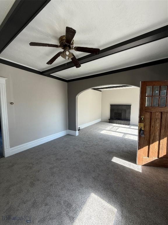 1717 Lowell, Butte, MT 59701 - unfurnished living room with arched walkways, ceiling fan, carpet, and ornamental molding