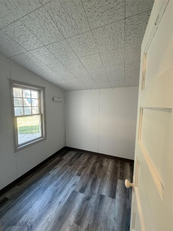 1717 Lowell, Butte, MT 59701 - empty room featuring vaulted ceiling and dark wood-style floors