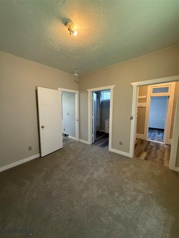 1717 Lowell, Butte, MT 59701 - unfurnished bedroom with carpet, a textured ceiling, and connected bathroom