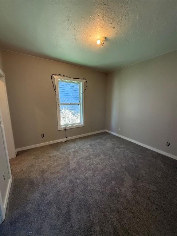 1717 Lowell, Butte, MT 59701 - empty room with carpet and a textured ceiling