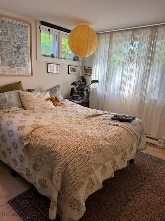 815 S 6th Ave, Bozeman, MT 59715 - bedroom with a baseboard radiator and wood finished floors