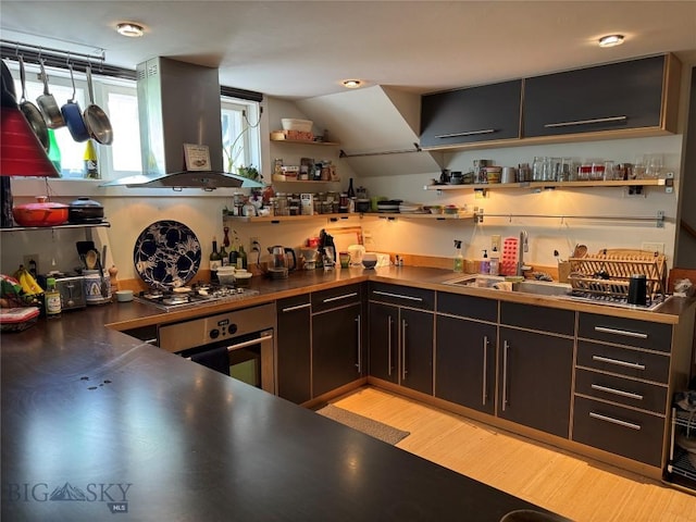815 S 6th Ave, Bozeman, MT 59715 - bar area featuring wall chimney exhaust hood, stainless steel appliances, light wood-style flooring, and vaulted ceiling
