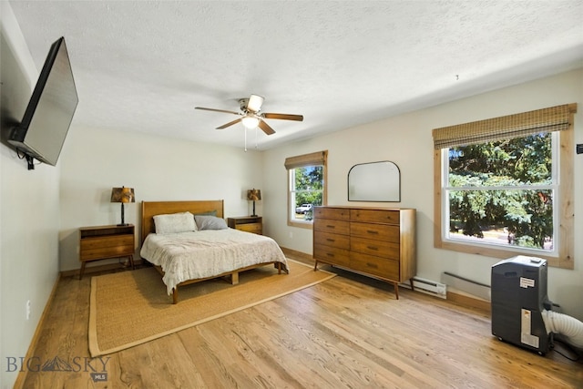 11 N Yellowstone Ave, Bozeman, MT 59718 - bedroom with light wood-type flooring, a textured ceiling, and a ceiling fan