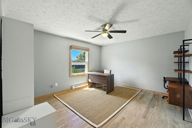 11 N Yellowstone Ave, Bozeman, MT 59718 - office with baseboard heating, a ceiling fan, wood finished floors, and a textured ceiling