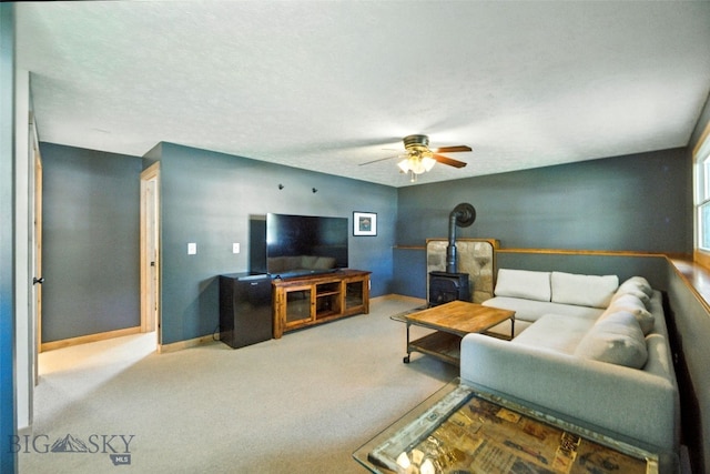 11 N Yellowstone Ave, Bozeman, MT 59718 - living room with a wood stove, a ceiling fan, and carpet flooring