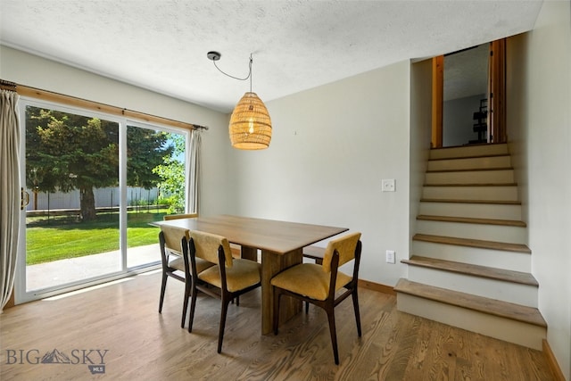 11 N Yellowstone Ave, Bozeman, MT 59718 - dining area featuring wood finished floors, stairs, and a textured ceiling