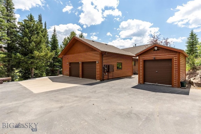 11540 Taiga Trl, Bozeman, MT 59715 - view of front facade featuring log veneer siding and a shingled roof
