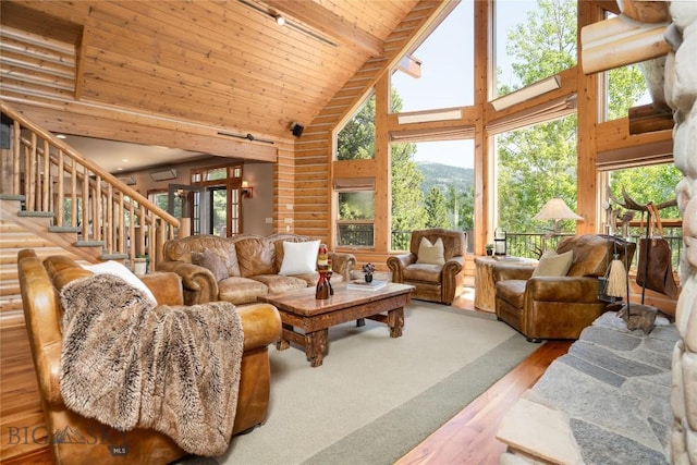 11540 Taiga Trl, Bozeman, MT 59715 - living area featuring high vaulted ceiling, wood finished floors, stairs, a mountain view, and a wood ceiling with exposed beams