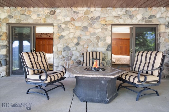 11540 Taiga Trl, Bozeman, MT 59715 - view of patio featuring an outdoor fire pit
