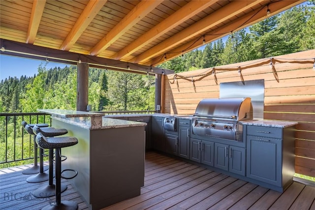 11540 Taiga Trl, Bozeman, MT 59715 - deck with exterior kitchen and a view of trees