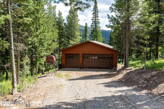 11540 Taiga Trl, Bozeman, MT 59715 - detached garage featuring a view of trees