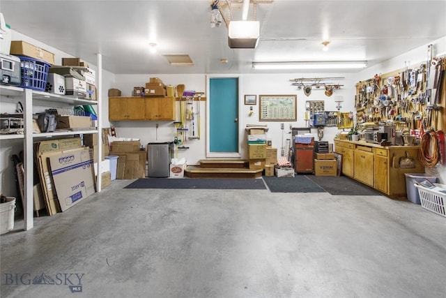 1406 Gilman Ave, Butte, MT 59701 - garage with a garage door opener and a workshop area