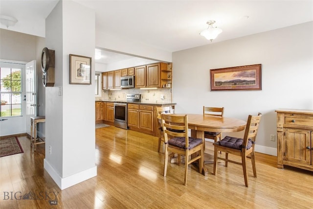 1406 Gilman Ave, Butte, MT 59701 - dining area with light wood-style floors and baseboards