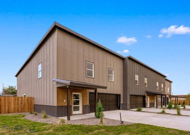 402 W Manhattan Ave Unit B, Manhattan, MT 59741 - modern home with an attached garage, board and batten siding, and concrete driveway