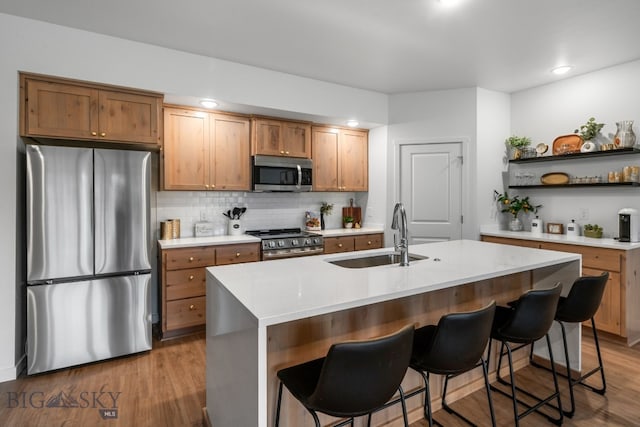 402 W Manhattan Ave Unit B, Manhattan, MT 59741 - kitchen with stainless steel appliances, open shelves, light countertops, a kitchen breakfast bar, and recessed lighting