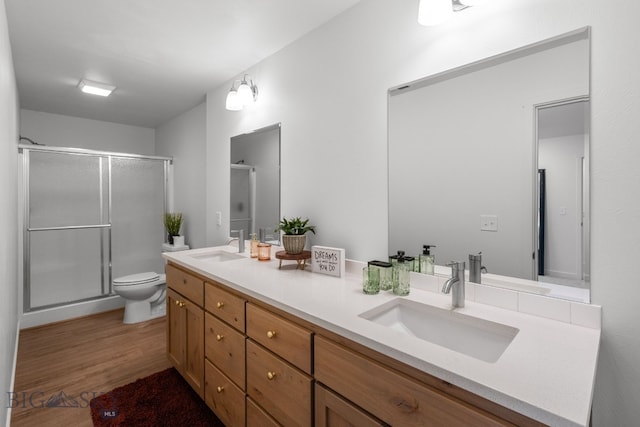 402 W Manhattan Ave Unit B, Manhattan, MT 59741 - full bathroom featuring double vanity, a shower stall, and wood finished floors