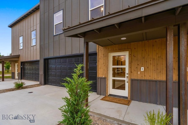 402 W Manhattan Ave Unit B, Manhattan, MT 59741 - property entrance featuring a garage, board and batten siding, and concrete driveway