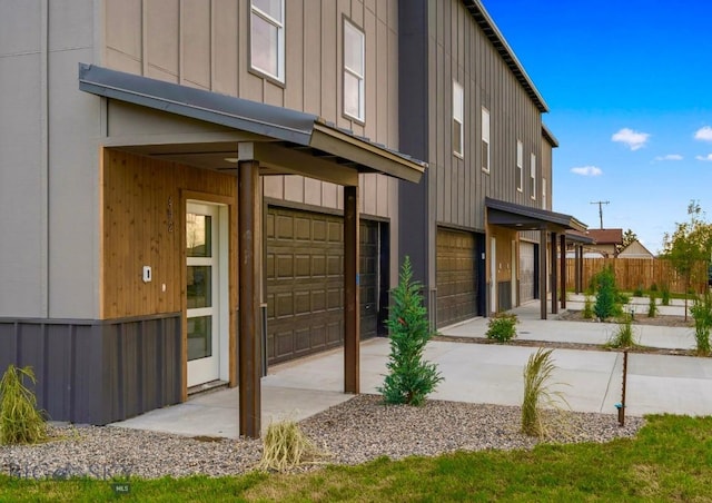 402 W Manhattan Ave Unit B, Manhattan, MT 59741 - view of side of property featuring board and batten siding, an attached garage, and driveway
