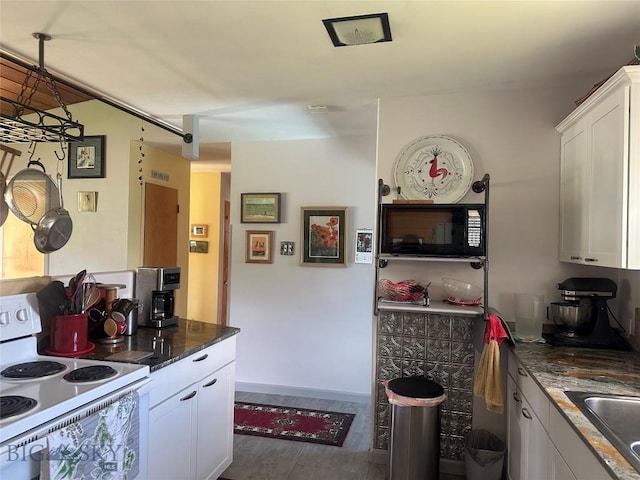 1914 Haggin, Anaconda, MT 59711 - kitchen with electric range, black microwave, white cabinetry, wood finished floors, and dark stone countertops