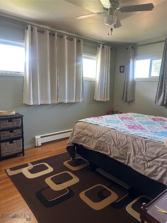 1914 Haggin, Anaconda, MT 59711 - bedroom featuring baseboard heating, wood finished floors, and ceiling fan