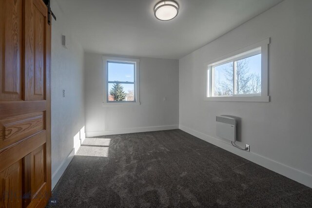 416 N 3rd St, Livingston, MT 59047 - unfurnished bedroom with dark carpet and baseboards