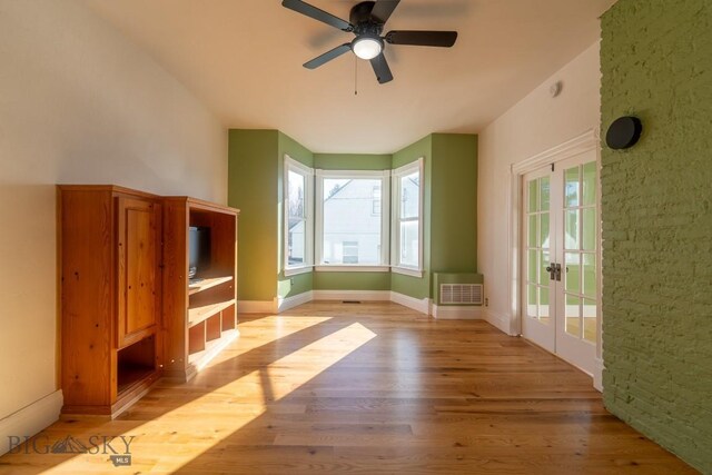 416 N 3rd St, Livingston, MT 59047 - unfurnished living room featuring light wood-type flooring, ceiling fan, and french doors
