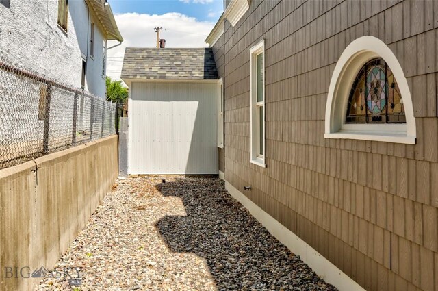 416 N 3rd St, Livingston, MT 59047 - view of side of property featuring roof with shingles