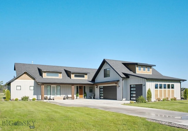 243 Tinkers Ln, Bozeman, MT 59718 - modern farmhouse style home featuring an attached garage, a front yard, board and batten siding, and concrete driveway