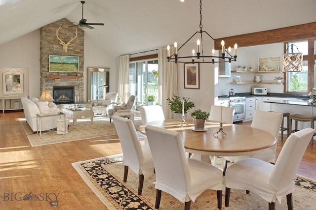 243 Tinkers Ln, Bozeman, MT 59718 - dining space featuring healthy amount of natural light, light wood-style flooring, ceiling fan, a chandelier, and high vaulted ceiling