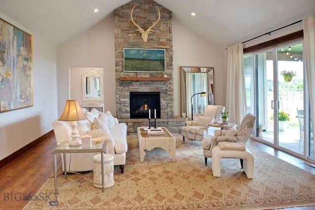 243 Tinkers Ln, Bozeman, MT 59718 - living area featuring wood finished floors, a stone fireplace, and high vaulted ceiling