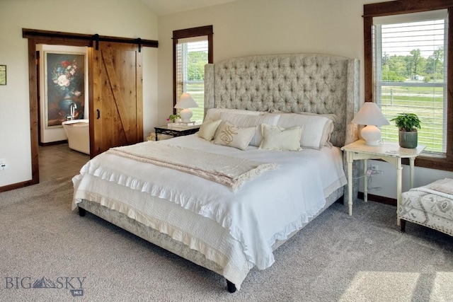 243 Tinkers Ln, Bozeman, MT 59718 - carpeted bedroom with a barn door and vaulted ceiling
