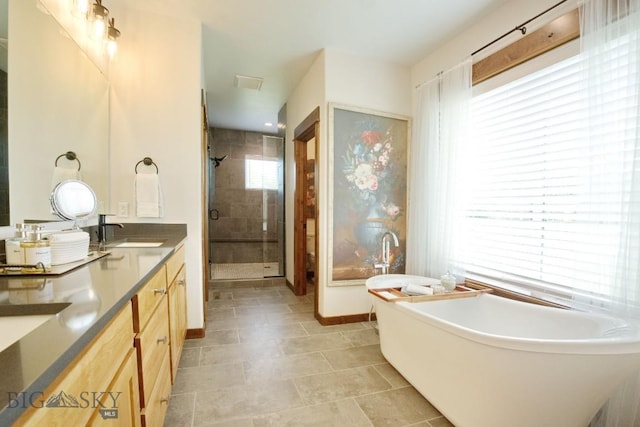 243 Tinkers Ln, Bozeman, MT 59718 - full bathroom featuring a shower stall, double vanity, and a freestanding tub