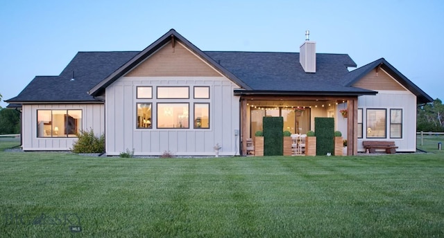 243 Tinkers Ln, Bozeman, MT 59718 - back of house featuring a chimney, a lawn, and board and batten siding