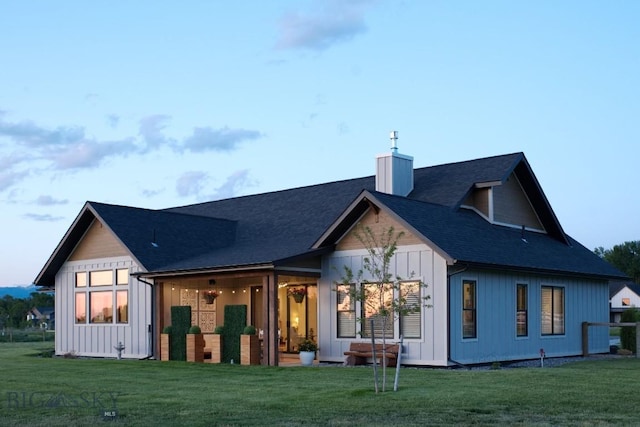 243 Tinkers Ln, Bozeman, MT 59718 - rear view of property with a lawn, a chimney, board and batten siding, and roof with shingles